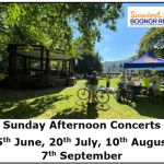 People gather in a sunny park with green grass and trees, sitting on benches and folding chairs facing a white bandstand during Sunday Afternoon Concerts in Bognor Regis, while event dates are listed at the bottom.